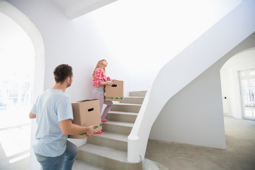 Local movers organising packed belongings in Kennington