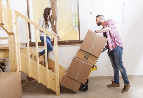 Removal team handling boxes and furniture in a Kennington flat move
