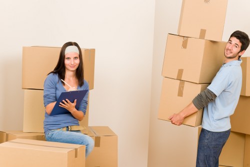Professional movers handling furniture in a Kennington flat